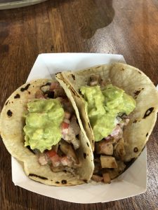 pic of 2 baja chicken tacos served in a cardboard dish