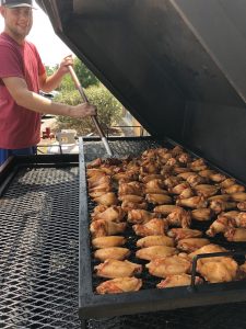 pic of Joe tending to wings on the smoker